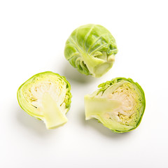 Halved brussels sprouts and whole cabbage close up