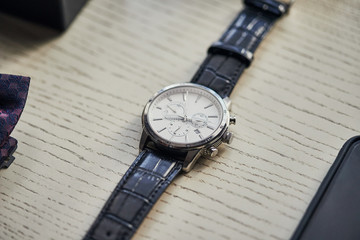 Men's classic watch (clock) on the table.