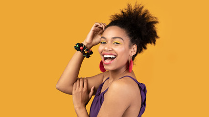 Happy black woman raising arm with new bracelet