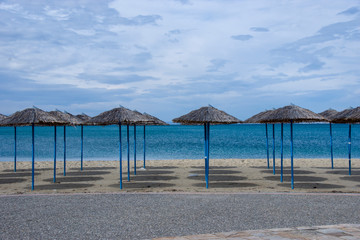 Reed umbrellas in empty beach in Peraia, of Thessaloniki, Greece