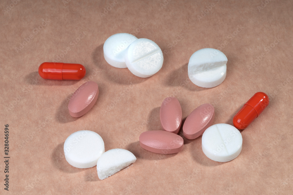 Wall mural white red and pink pills. drugs for treatment, top view.