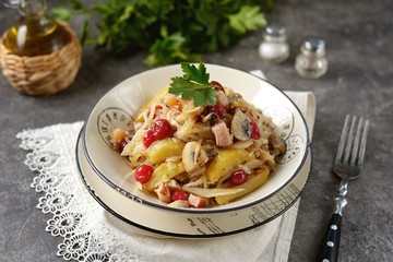 Stewed potatoes with smoked meat, cabbage, mushrooms and cranberries.