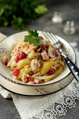 Stewed potatoes with smoked meat, cabbage, mushrooms and cranberries.