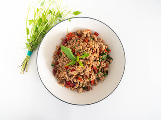 Stir fried basil with minced on a white plate,Thai food hot and spicy flavor. The ingredients are basil, garlic. Minced pork and Chili pepper,White background