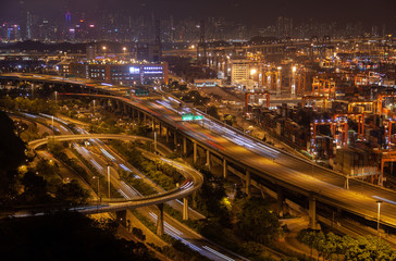 Fototapeta na wymiar Container port Hong Kong overpass road with orange illumination