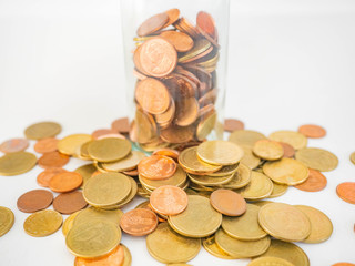 Thai Baht Coins colors Gold set in the mountains,Is the currency of Thailand.For business expenses,Coin is in a jar of money saving,White background