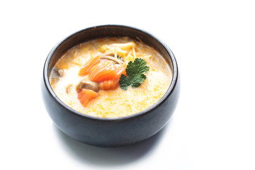 Tom yum, a spicy soup with coconut milk, shrimps and mushrooms. Traditional Japanese cuisine. Eastern cuisine. Dish on a white background