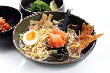 Ramen with salmon, mushrooms and egg. Traditional Japanese cuisine. Eastern cuisine. Dish on a white background