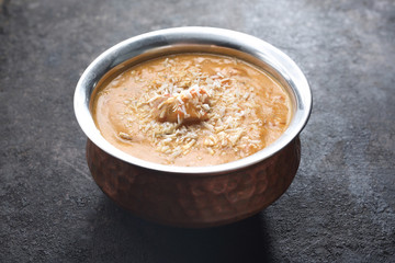Curry cream with chicken based on coconut milk, served with coconut flakes. Traditional Indian cuisine, Indian cuisine