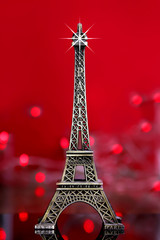 Fototapeta na wymiar eiffel tower souvenir with red background and lights