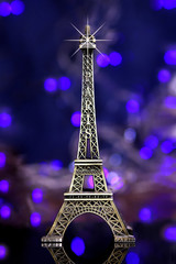 eiffel tower souvenir with blue background and lights