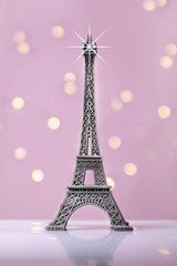 Fototapeta na wymiar eiffel tower souvenir with pink background and lights