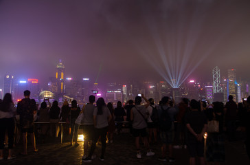 crowds of tourists visit Hong Kong embankment