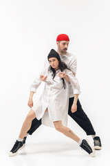 Youth. Trendy fashionable couple isolated on white studio background. Caucasian woman and man posing in basic minimal stylish clothes. Concept of relations, fashion, beauty, love. Copyspace.