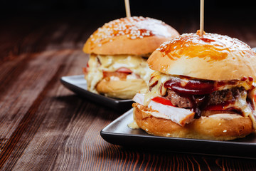 Two mouth-watering, delicious homemade burger used to chop beef. on the wooden table.