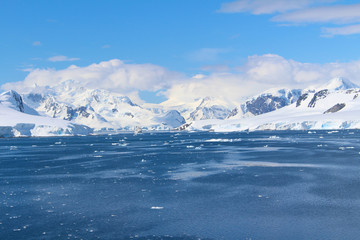 Fototapeta na wymiar Frozen coasts, icebergs and mountains of the Antarctic Peninsula. The mountains at Paradise Bay on the Danco Coast, Antarctica