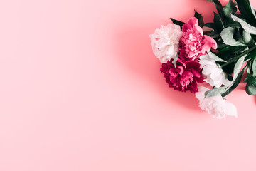 Beautiful flowers composition of peonies. Pink and white peonies flowers on pastel pink background. Flat lay, top view, copy space