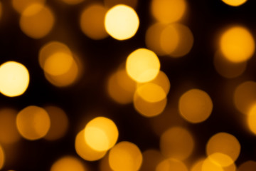 Obraz premium Bokeh lights,Bokeh lights background,Gold glitter with bokeh effect on dark background.
