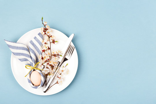 Easter table setting with egg in napkin Easter Bunny.