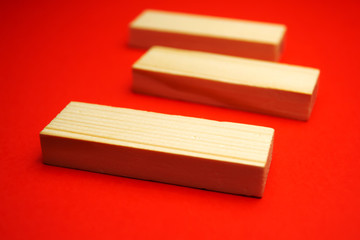 Three wood blocks on a red background