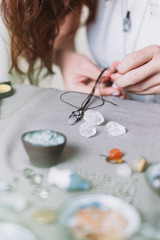 Obraz na płótnie Canvas Woman making handmade gemstone jewellery, home workshop. Artisan woman creates jewellery. Art, hobby, handcraft concept
