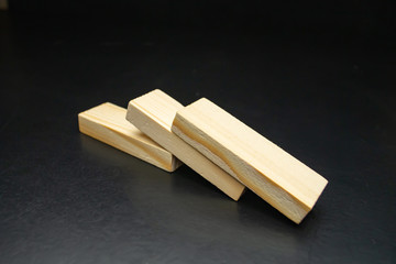 Three wooden blocks on a black background