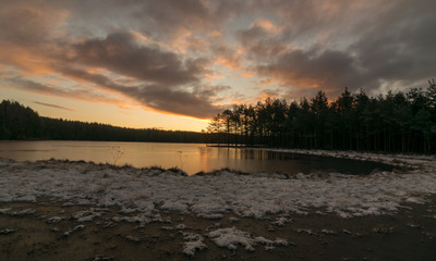 landscape with early sunrise by the lake, heaven sky, black tree silhouettes.