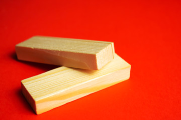 Two wood blocks on a red background