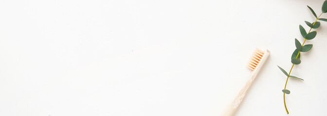 bamboo toothbrush with little green plant on the white background. Concept eco friendly, copyspase, zero waste.