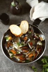 Shell mussels in creamy garlic cheese sauce.