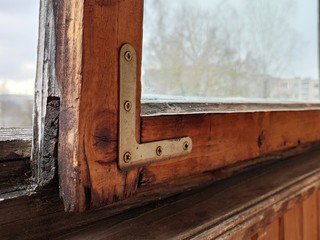 old wood aged window with metallic support