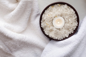 Plakat Top view of sea salt, candle, white towels.Concept of spa treatments