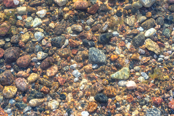 Background of stones on a sandy seabed