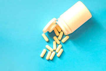 Bottle with pills on a blue background.