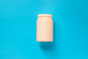 Bottle with pills on a blue background.