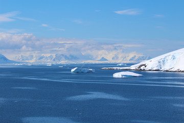 Icebergs and mountains of the Antarctic Peninsula. The mountains in the Gerlache Strait in the Danco Coast, Antarctica