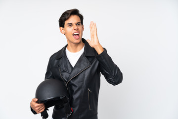 Man holding a motorcycle helmet over isolated white background shouting with mouth wide open