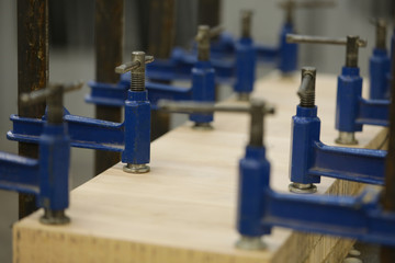 Metallic utilities used on carpentry workbenches for wood crafting works in big rusty workshop...