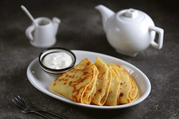 Homemade potato pancakes with sour cream.