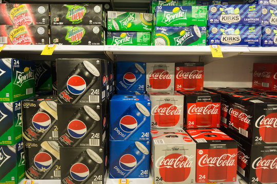 Gold Coast, Australia - May 09 2018: Boxes of soda  from various brands such Coca Cola, Sprite and Pepsi as are displayed in a supermarket.