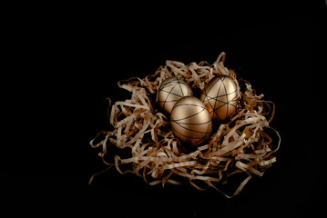 Easter goldenand white decorated eggs in nest on black background . Minimal easter concept copy space for text. Top horizontal view