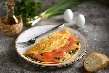 Omelet with green onions, parsley and salted salmon. Healthy food.