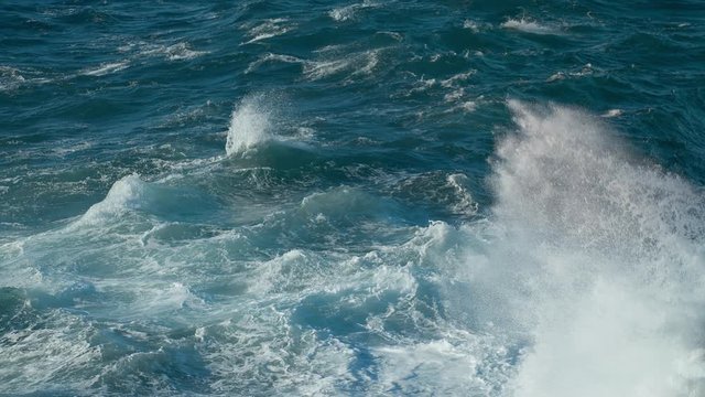 Extreme Wave crashing coast Awesome power of waves breaking over dangerous rocks spray wind waves Sea Huge swell hitting shoreline.  Tide turns into pearl drops and splashes Powerful Ocean shot 4.6K