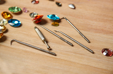 Gemstones and tools on table in jeweller's workshop