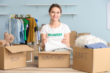 Volunteer with donations for poor people indoors