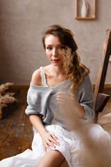 Naklejka premium Beautiful attractive sensual dreamy, attractive inspired girl in home clothes resting at home, enjoying privacy, self- care, self- love, creative workshop