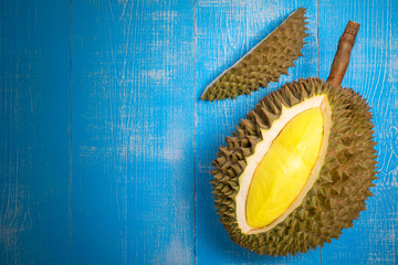 Fresh Durian fruit on blue wood background,Durian fruit with delicious golden yellow soft flesh.