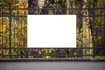 Blank white banner for advertisement on the fence of the park in the city