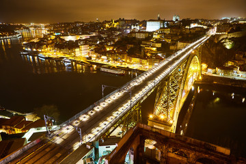 Fototapeta na wymiar Night View of cityscape of Porto, Portugal over Dom Luis I Bridge and Douro River
