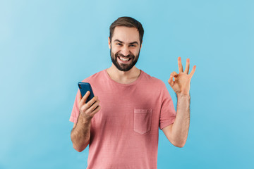 Fototapeta premium Portrait of a young cheerful bearded man wearing t-shirt